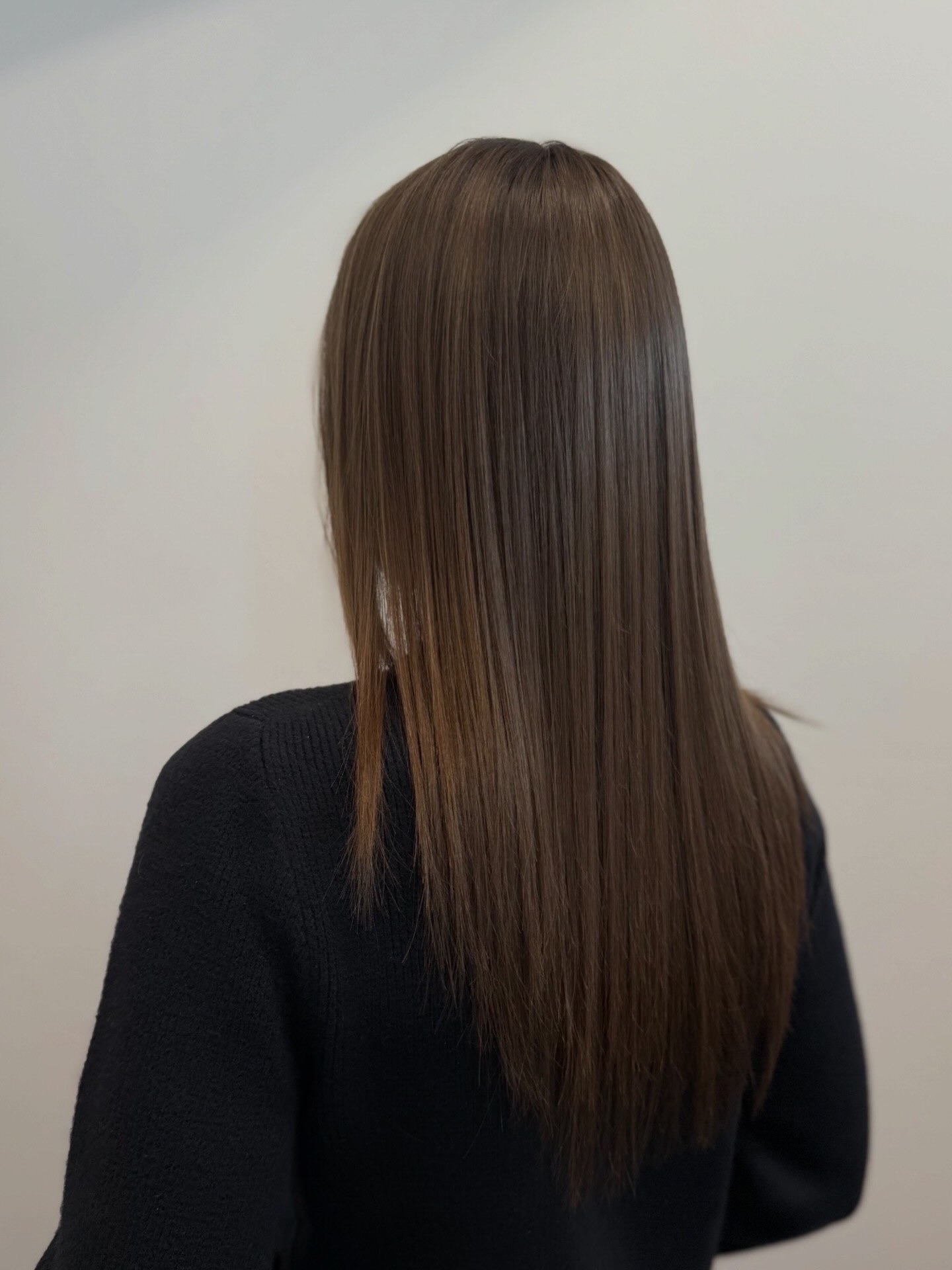 Straight brunette hair extension blend viewed from the back
